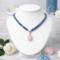 Bead & Braid Collective handmade blue Kumihimo necklace on white bust with rose quartz pendant, artisan beaded jewelry